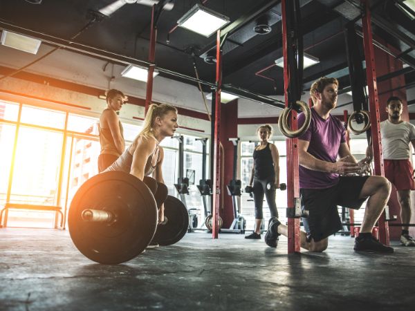 mulher levantando peso em um box de crossfit