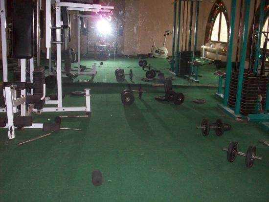 Sala de musculação de uma academia bem bagunçada.